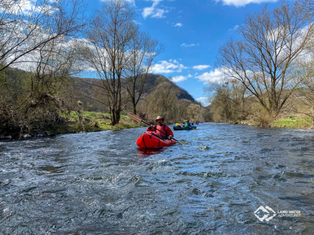 Sonnenschein und Frühling auf der Nahe, ein rotes Packraft im Vordergrund